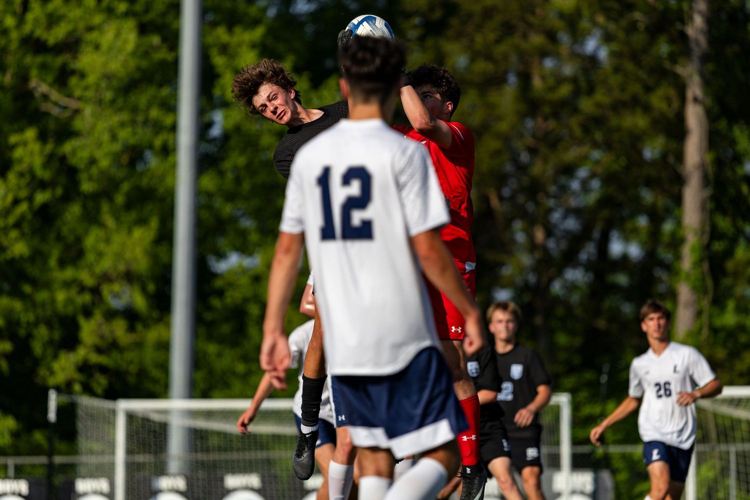 John Mallow head-bunts the soccer ball against Concord High School