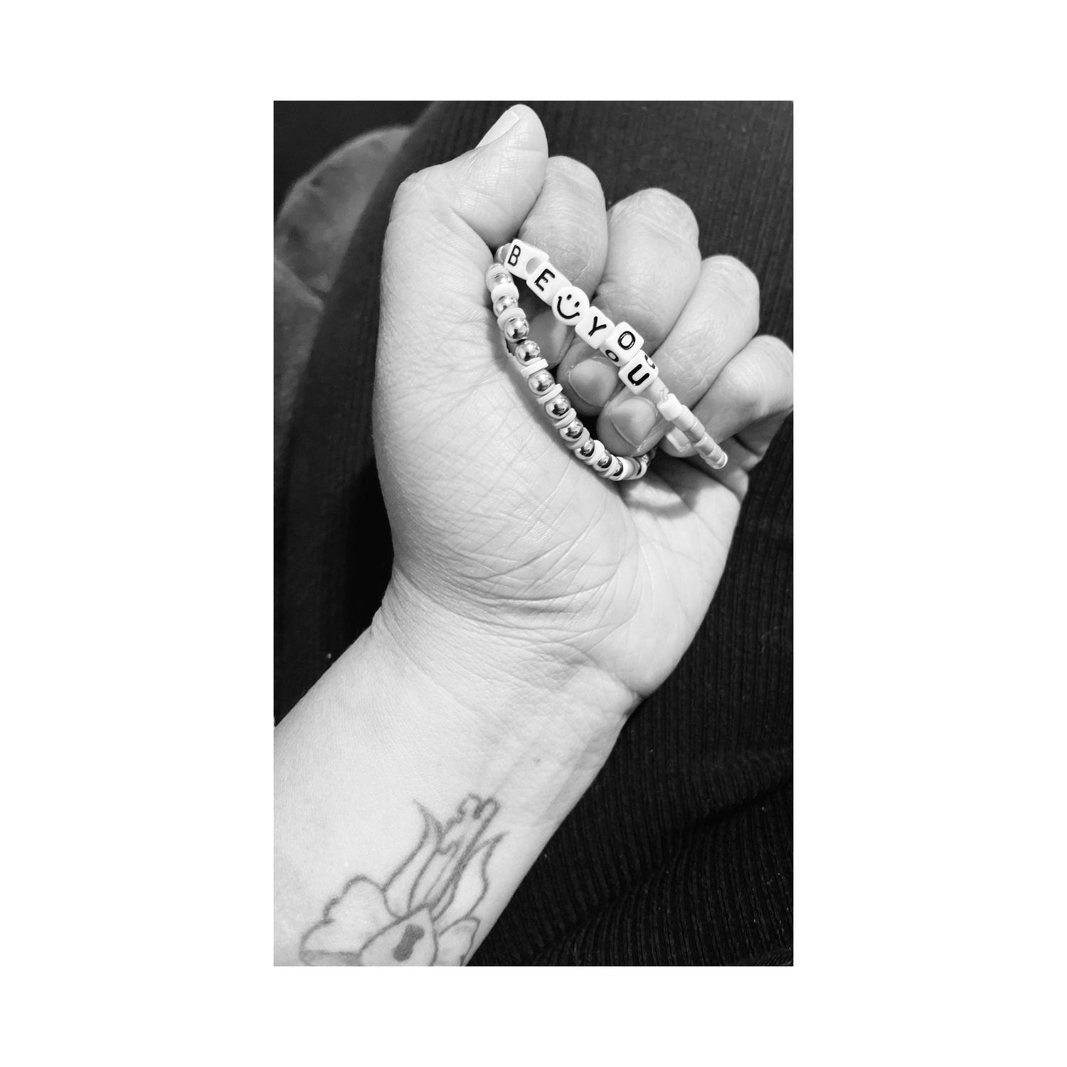 A sequence of black and white photos showing a hand with text or markings written on the palm.
