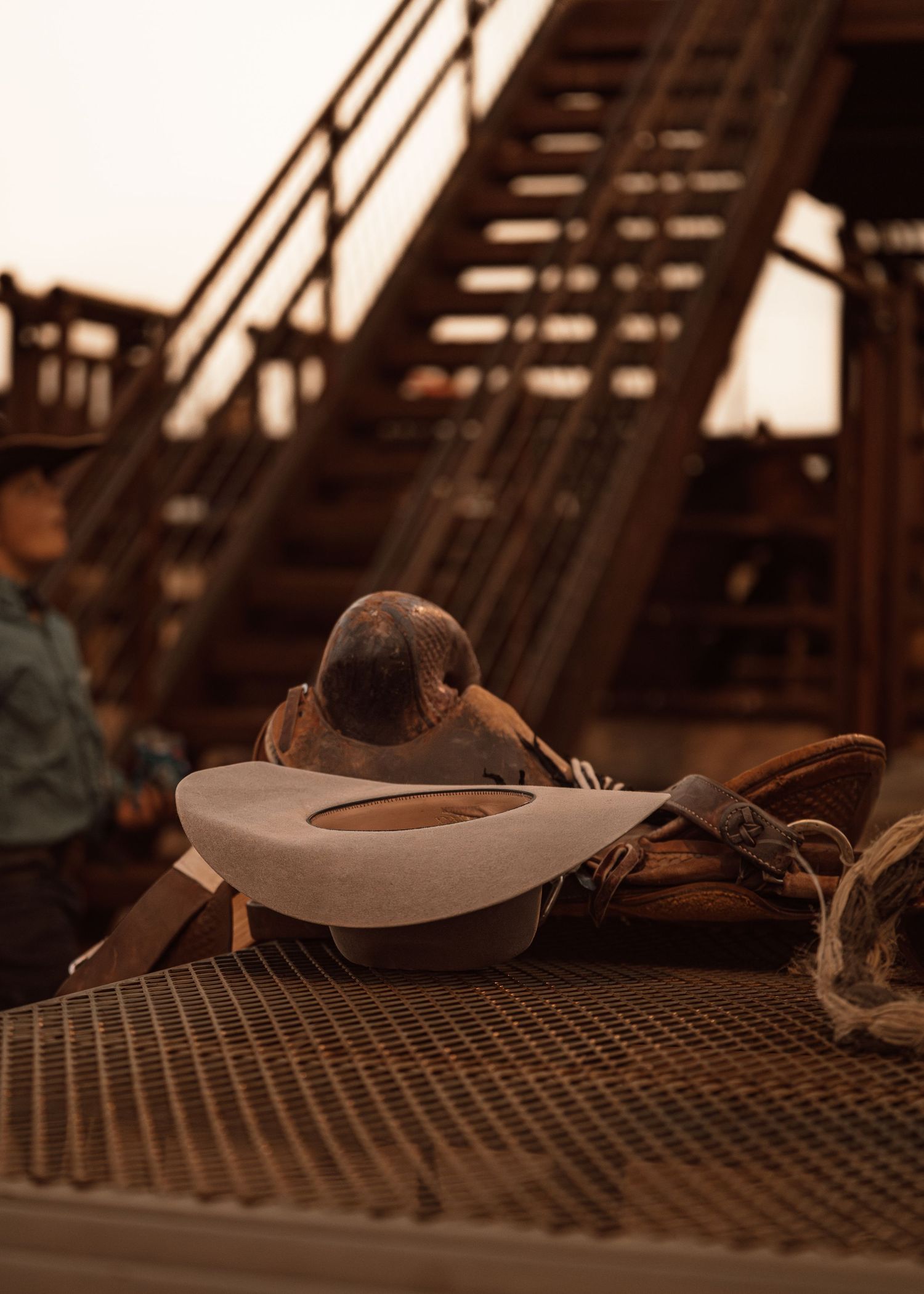 A sepia-toned close-up sequence showing a cowboy hat resting on a textured metal grating surface.