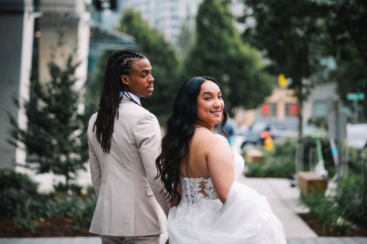 Wedding couple sharing intimate moments during an outdoor photoshoot in an urban setting.
