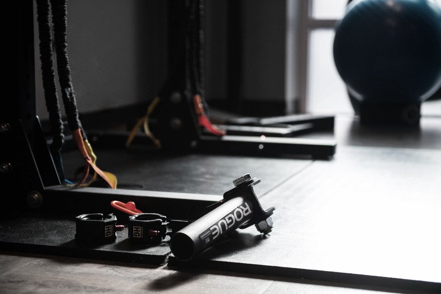 Exercise equipment and resistance bands in a dimly lit fitness studio.