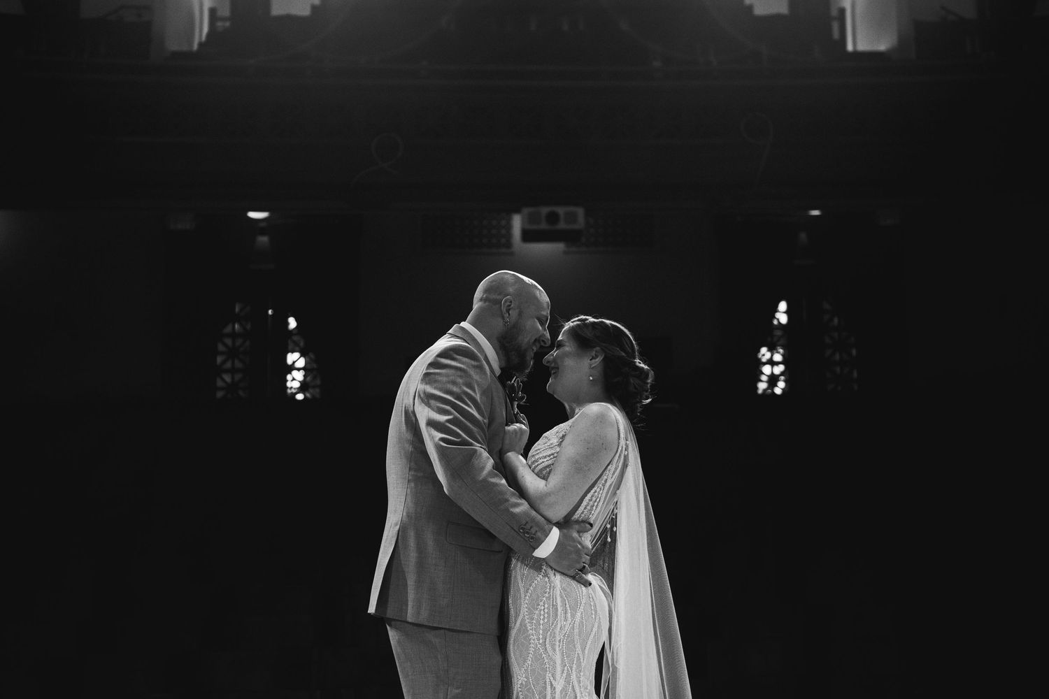 Intimate black and white moment captured during a wedding dance.