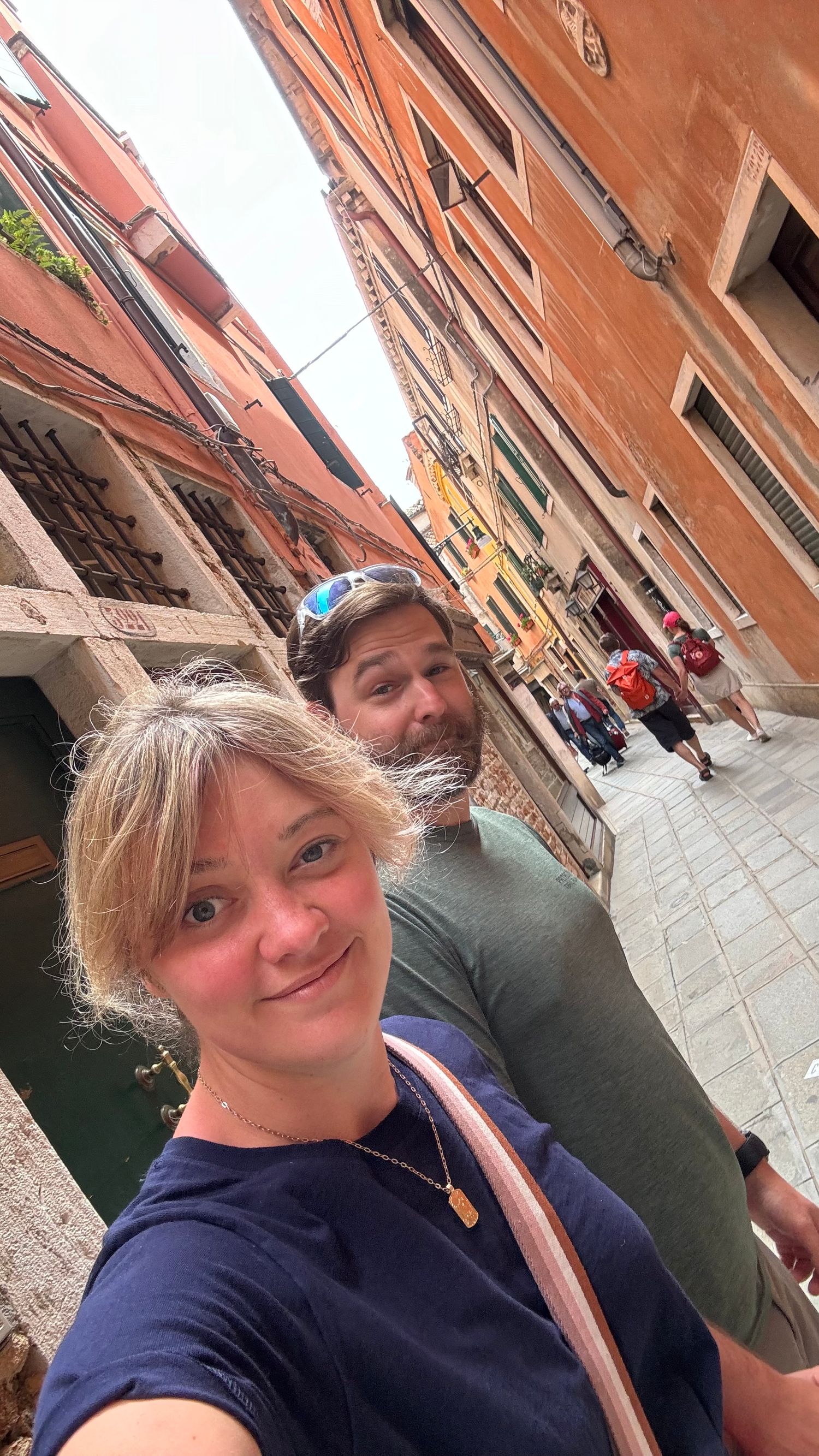 View of narrow alleyways with orange buildings in Venice, Italy.