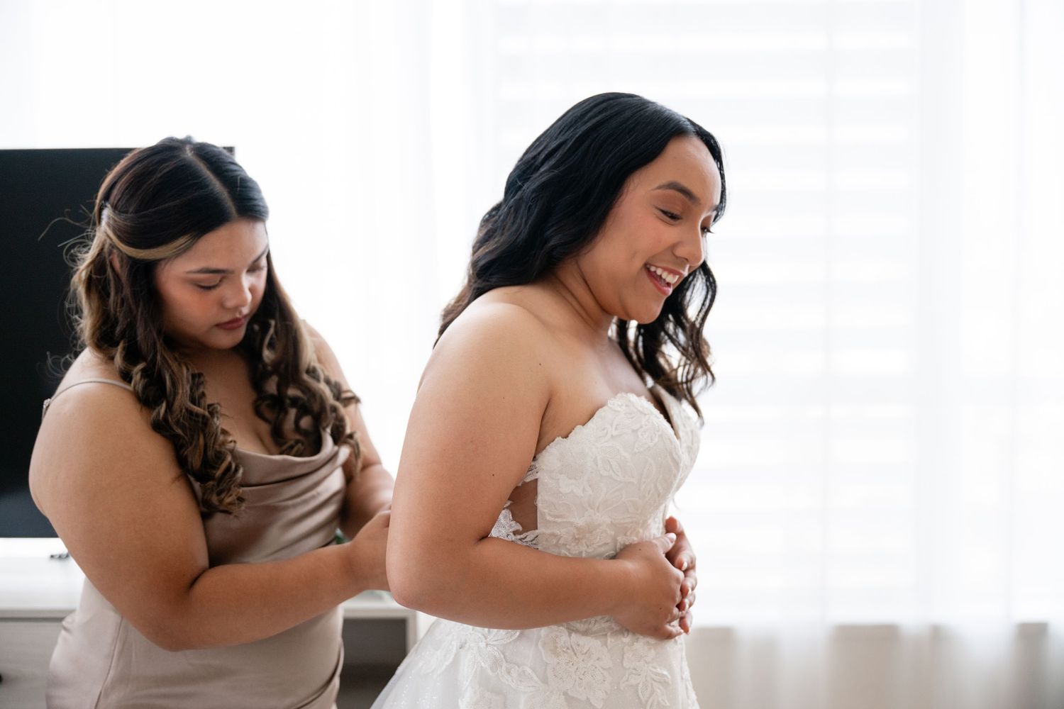 Intimate embraces shared between two people wearing white dresses during a wedding photoshoot.