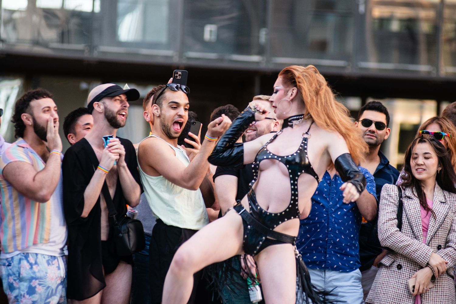 Energetic performers entertain an enthusiastic crowd during a poolside celebration.