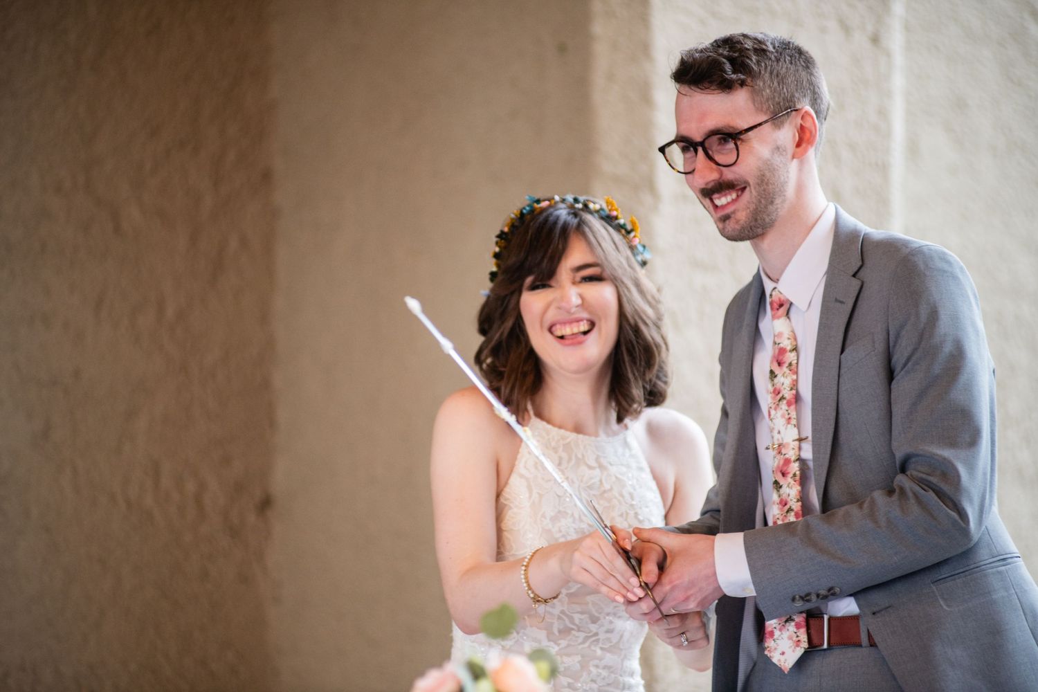 A joyful moment during a wedding ceremony in an indoor venue.
