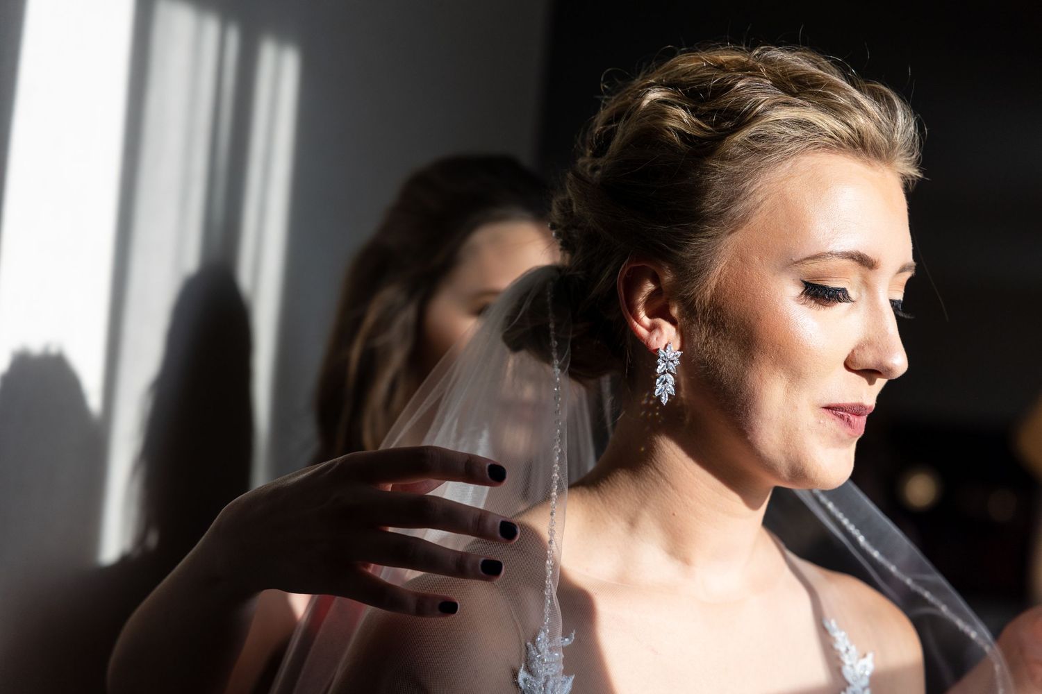 Side profile view of an elegant bride with dramatic lighting and shadows.