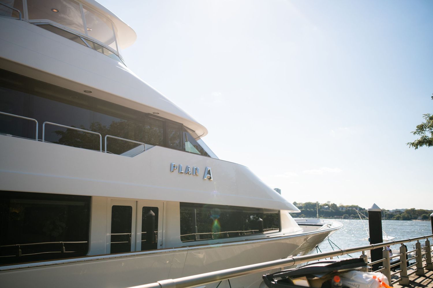 Luxury yacht 'Plan A' docked at a marina on a bright sunny day.