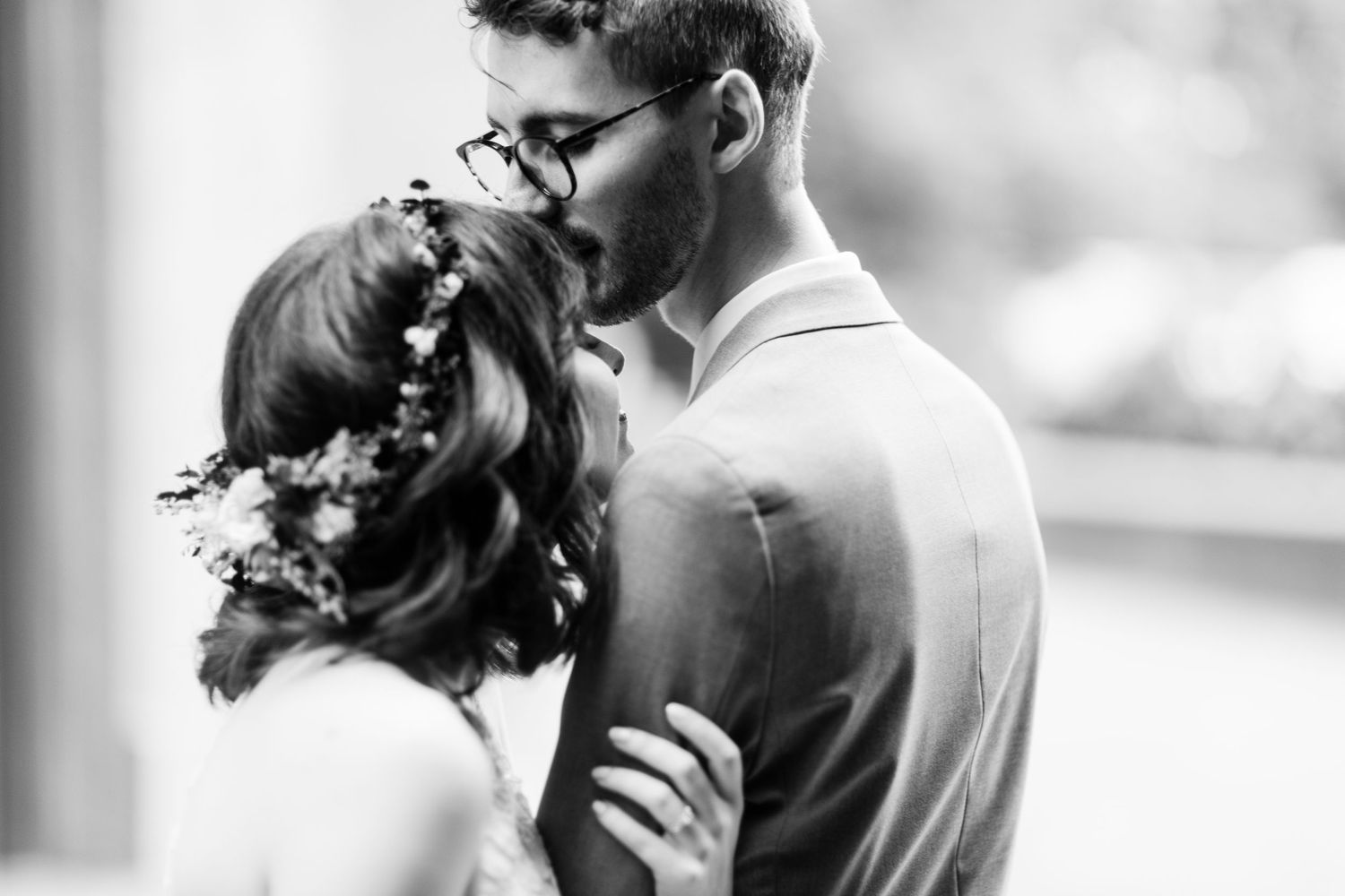 Intimate black and white portrait of newlyweds sharing tender moment.