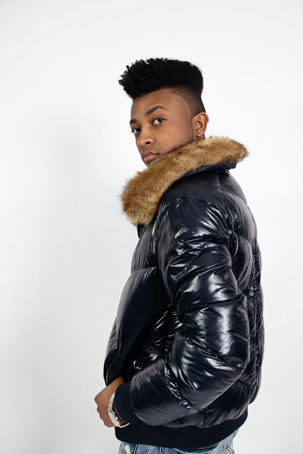 Stylish winter coat with fur trim collar shown in studio portrait against white background.