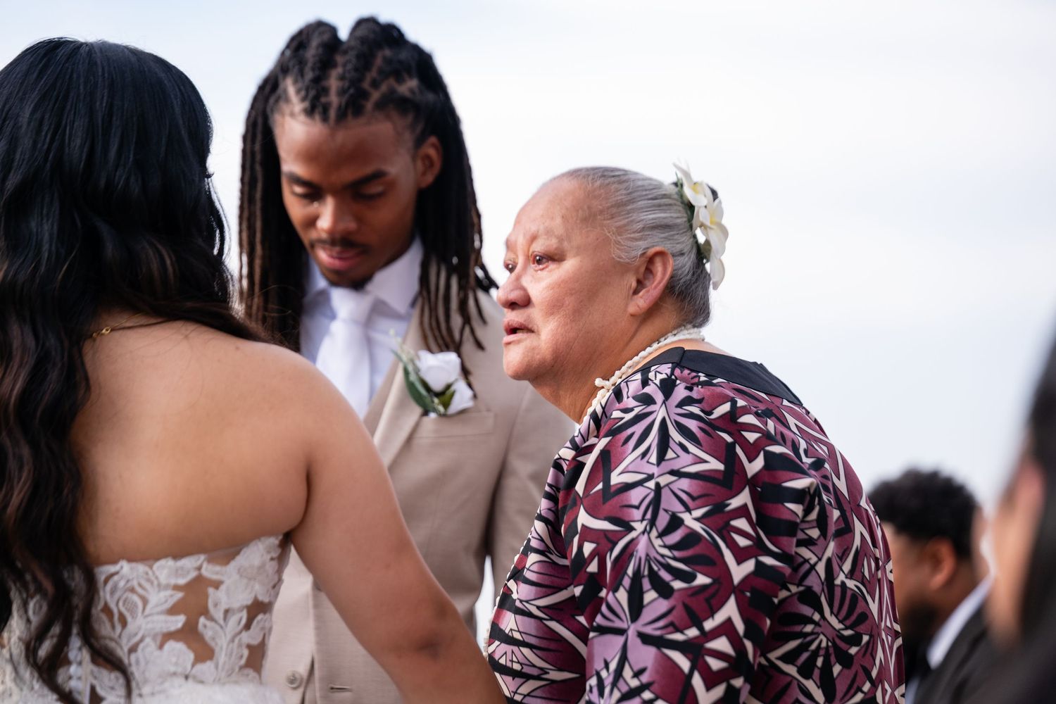 A collection of photos showing various people hugging and engaging in conversation at an outdoor gathering.