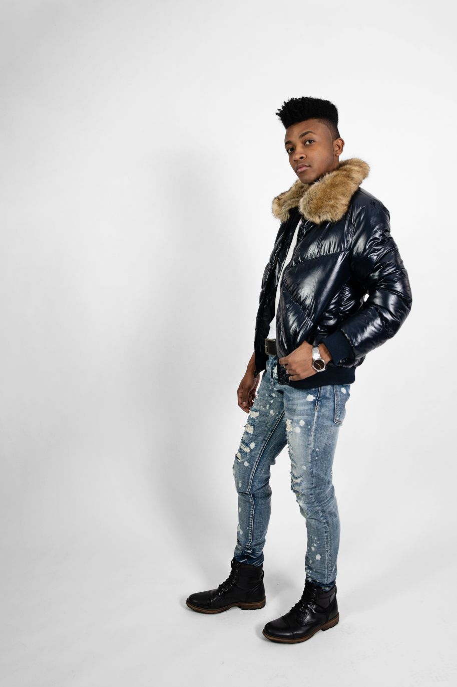 Full-length shot of winter fashion featuring glossy puffer coat and combat boots.