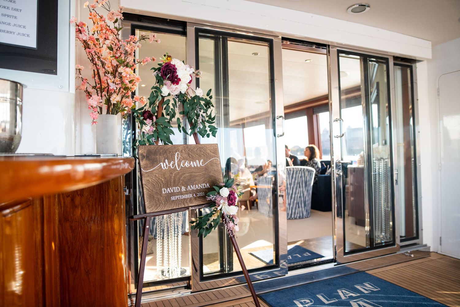 Elegant entrance with sliding glass doors decorated with pink floral arrangements.