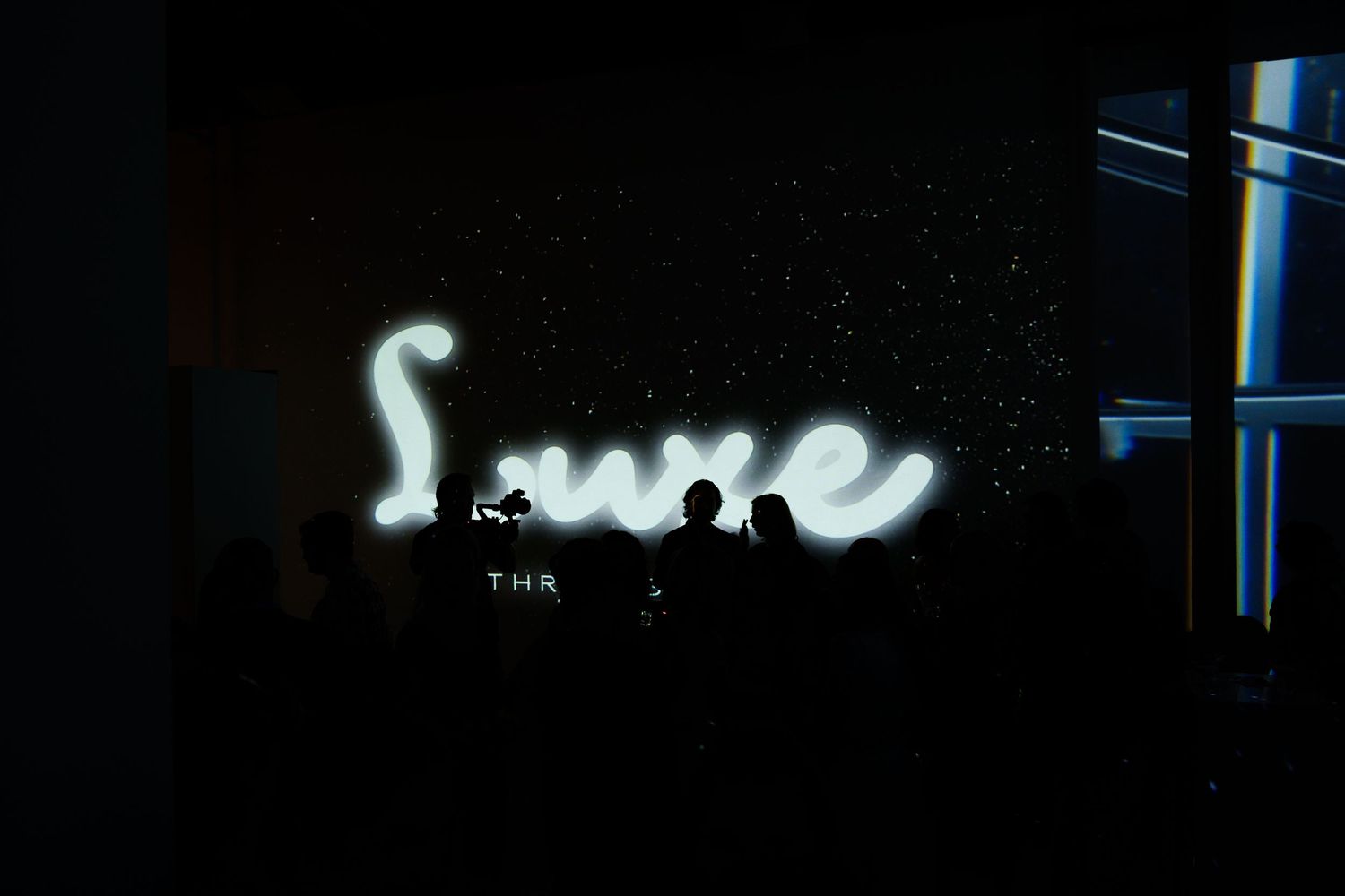 Five dark sequential storefront images show glowing neon signs and lit windows in an urban nighttime setting.