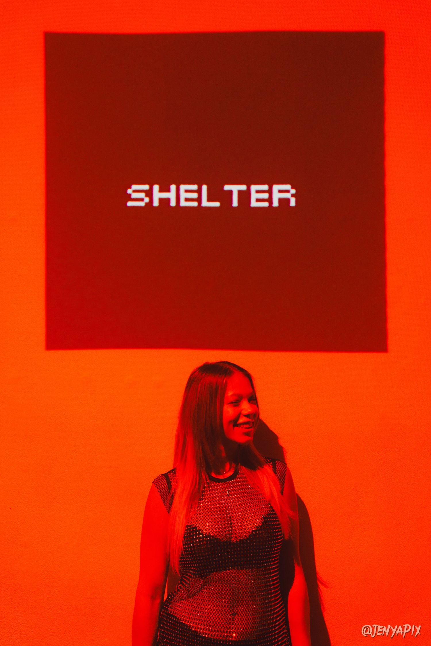 The word SHELTER displayed above in red lighting at a music venue.