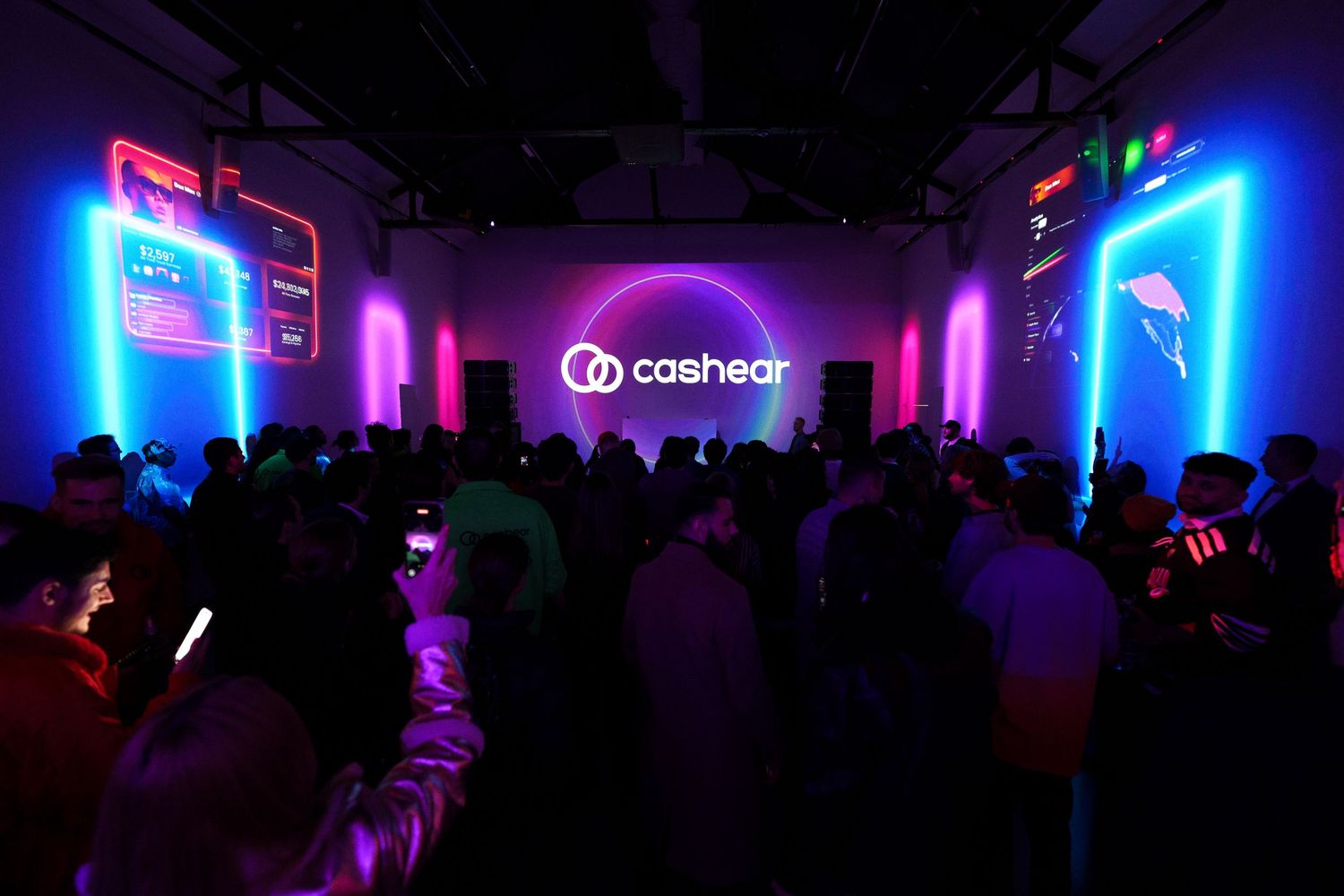 Nightclub interior with Cashapp branding lit by neon blue and pink lights with crowd in silhouette.