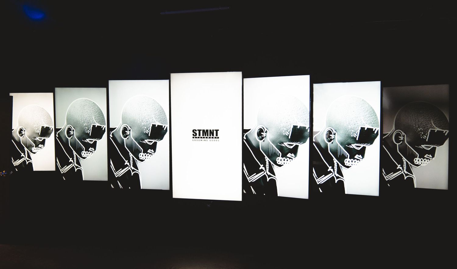 Black and white artistic display panels showing repeated portraits creating a dynamic visual sequence.
