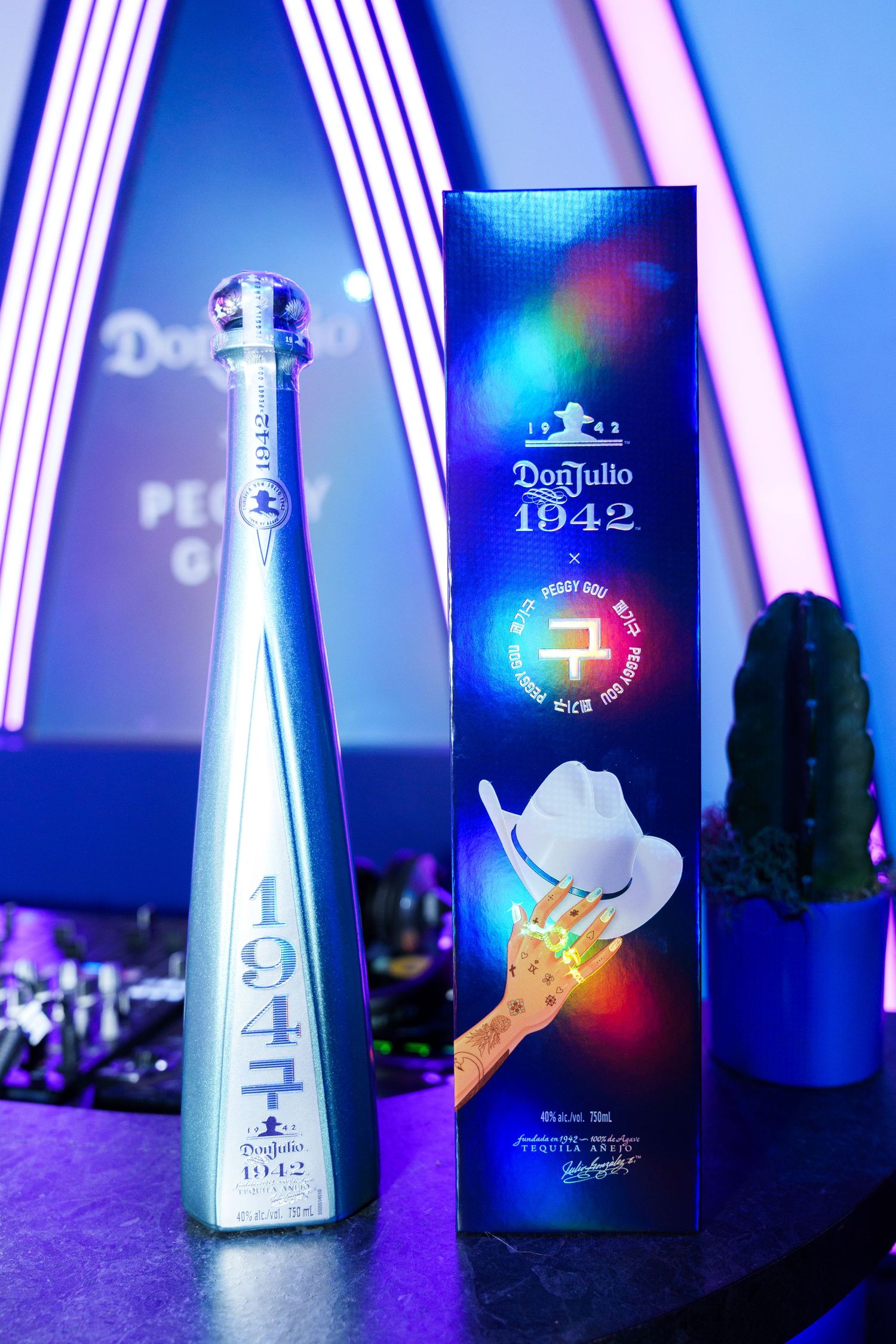 Don Julio 1942 tequila bottle and packaging illuminated with blue neon lighting on display.