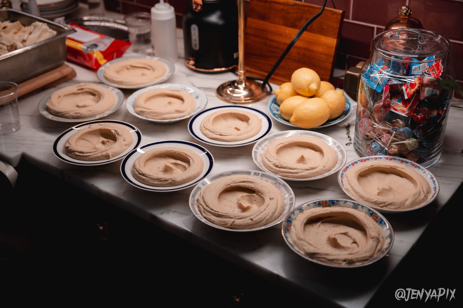 Row of plated chocolate desserts arranged on catering service counter.