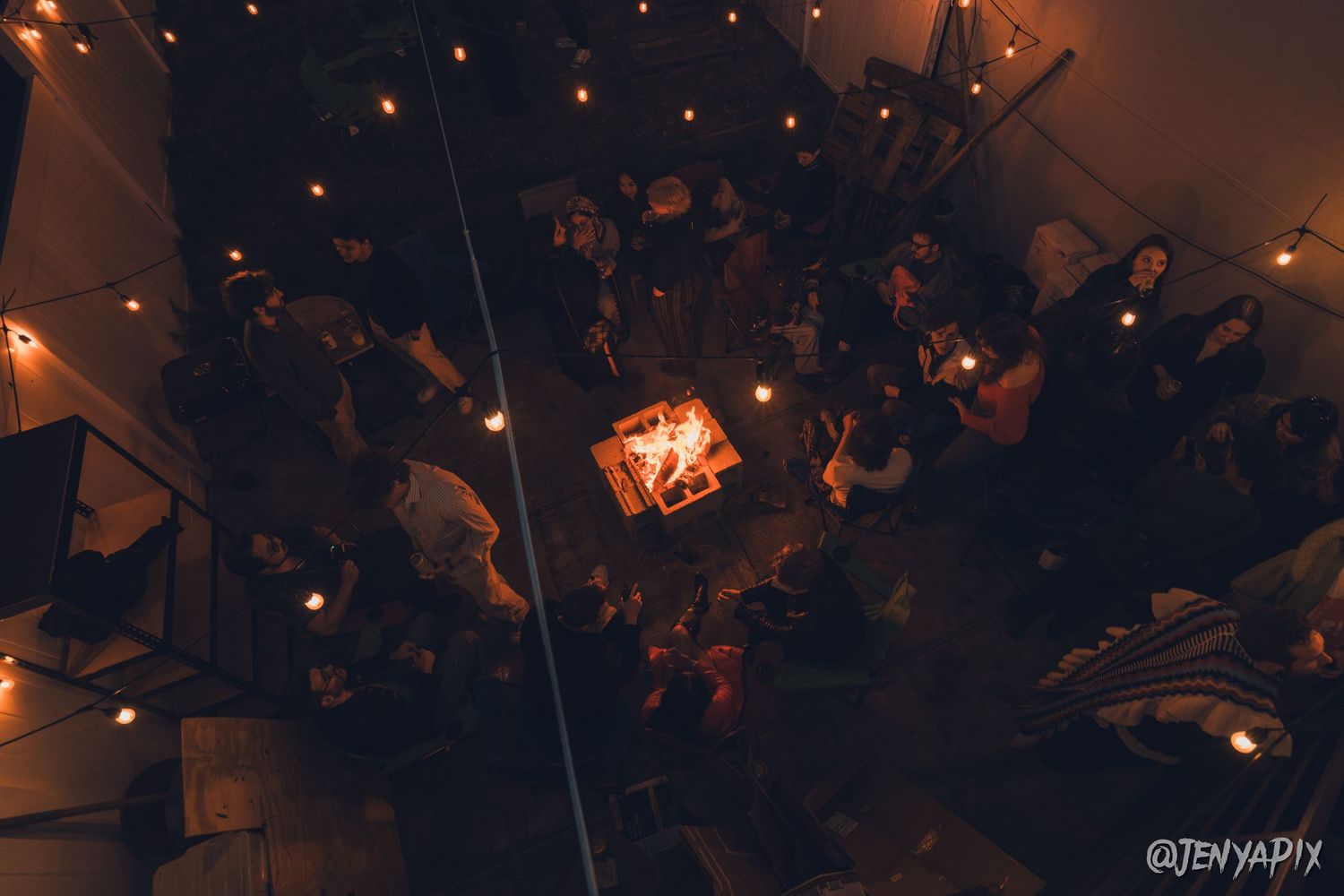 Overhead view of a crowded nighttime gathering with ambient lighting.
