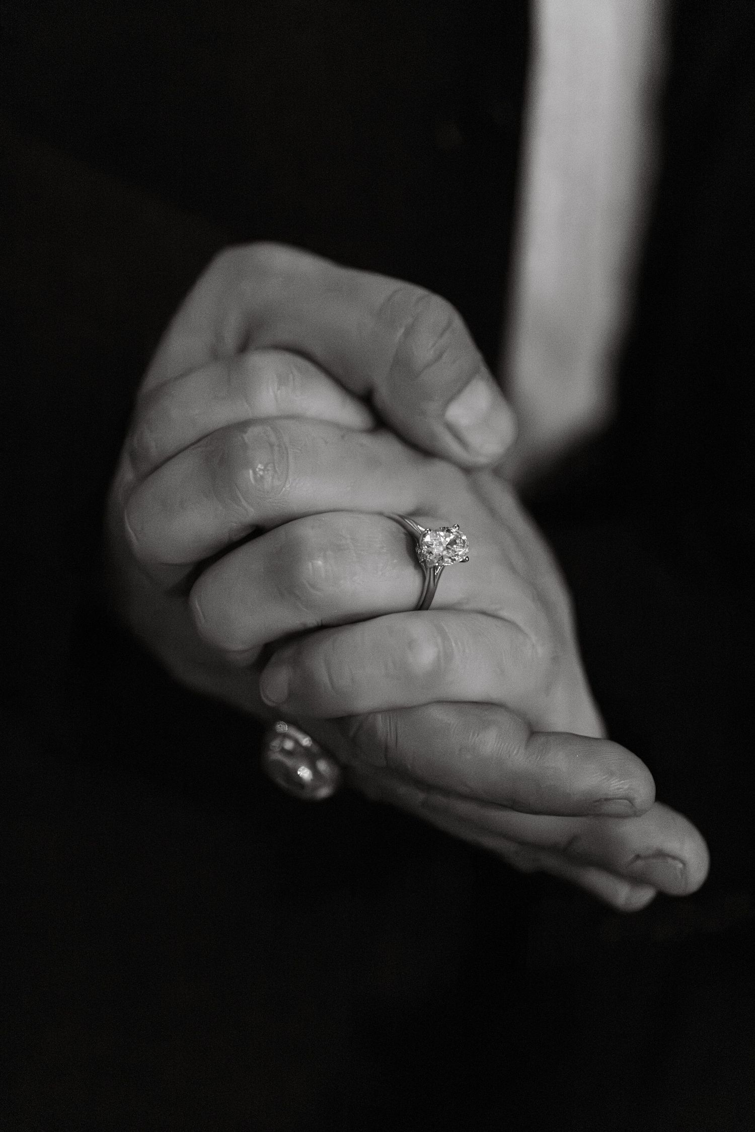 Black and white close-up photo series showing clasped hands with a diamond ring, symbolizing engagement or marriage.