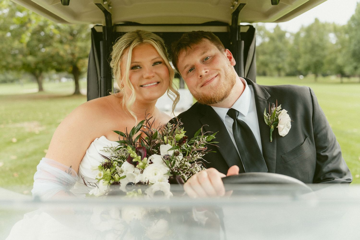 A happy couple shares tender moments in a wedding car and outdoor setting during their special day. Located in Bellbrook, Ohio.