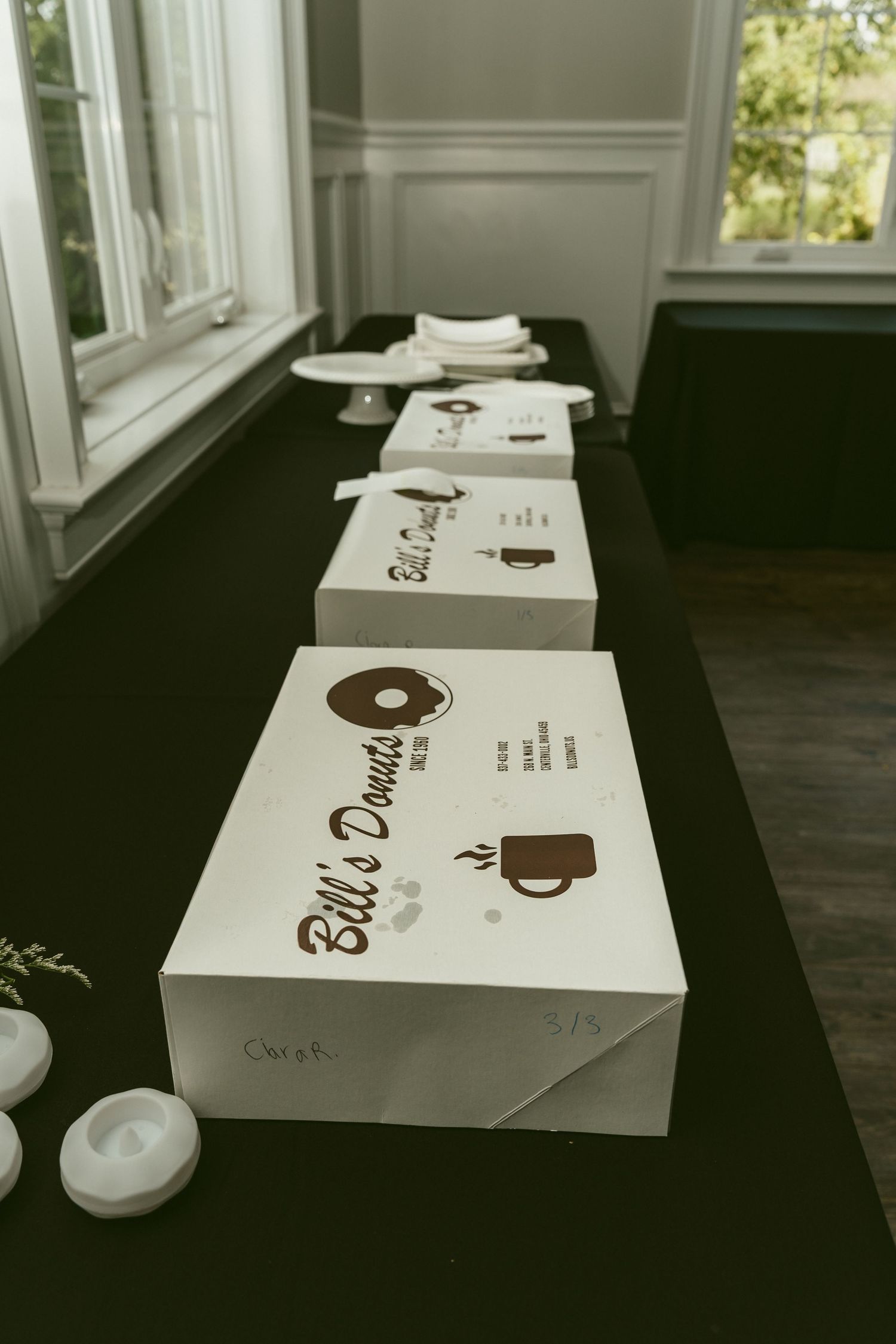 A series of white boxes with coffee-themed branding shown in a progressive diagonal composition. Located in Bellbrook, Ohio.