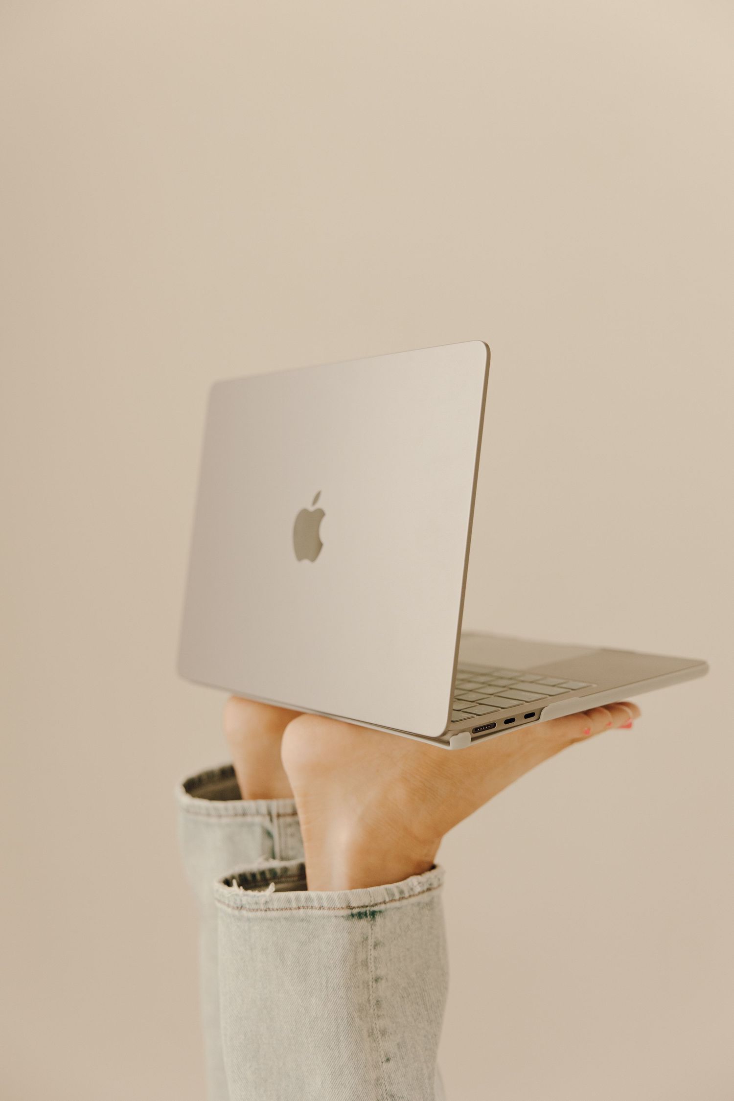 Woman holding laptop with feet