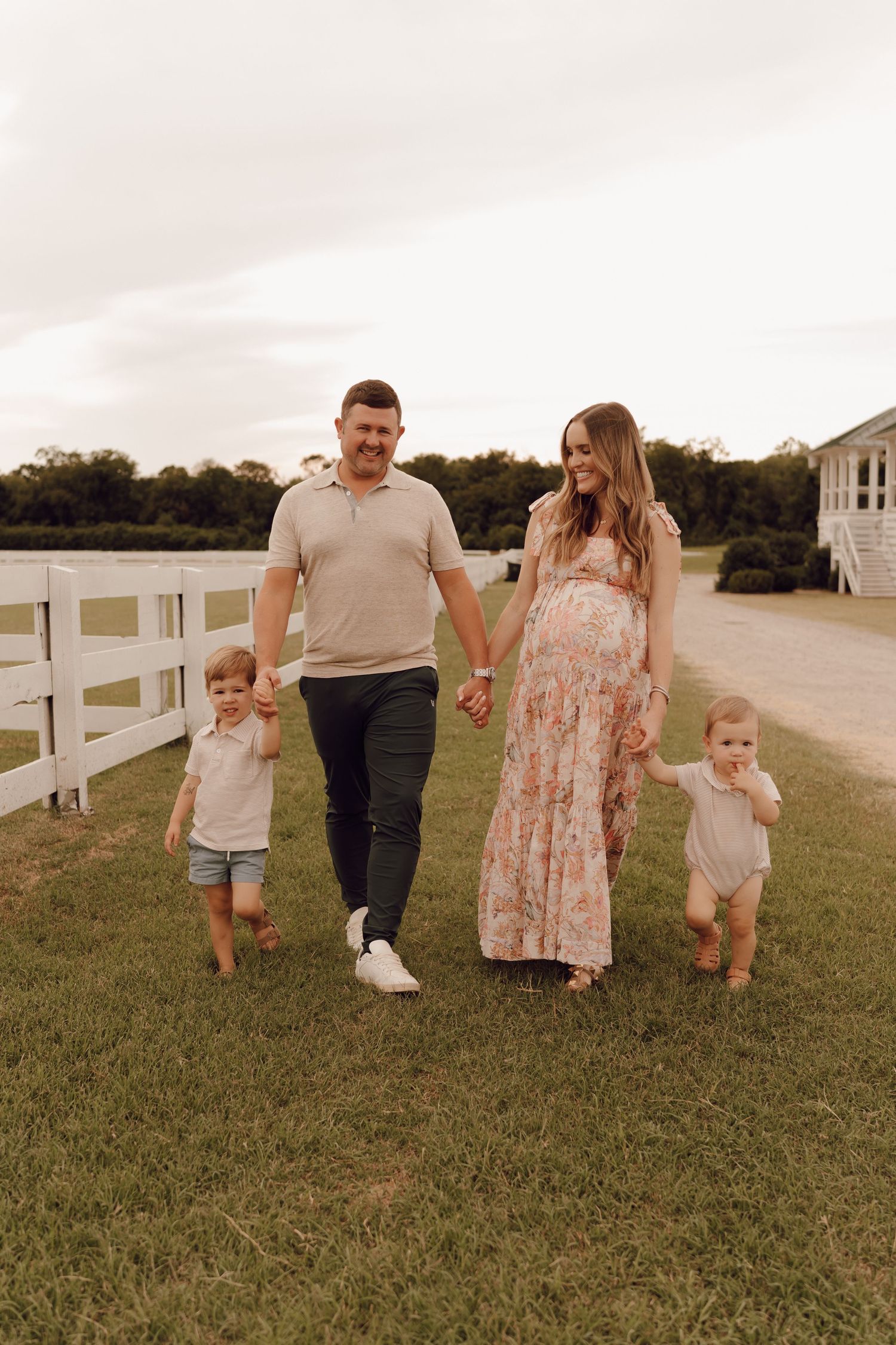 Casual family photo session with parents and children, captured in a lush park setting.