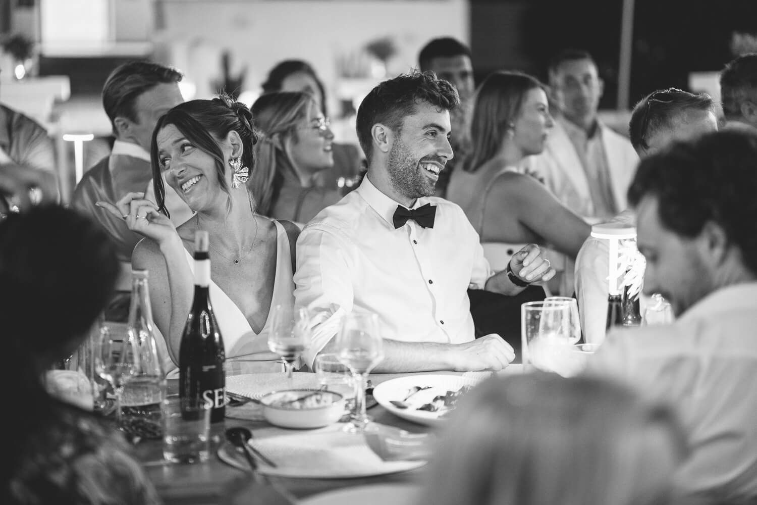 UK wedding guests laughing and cheering at the dinner tables