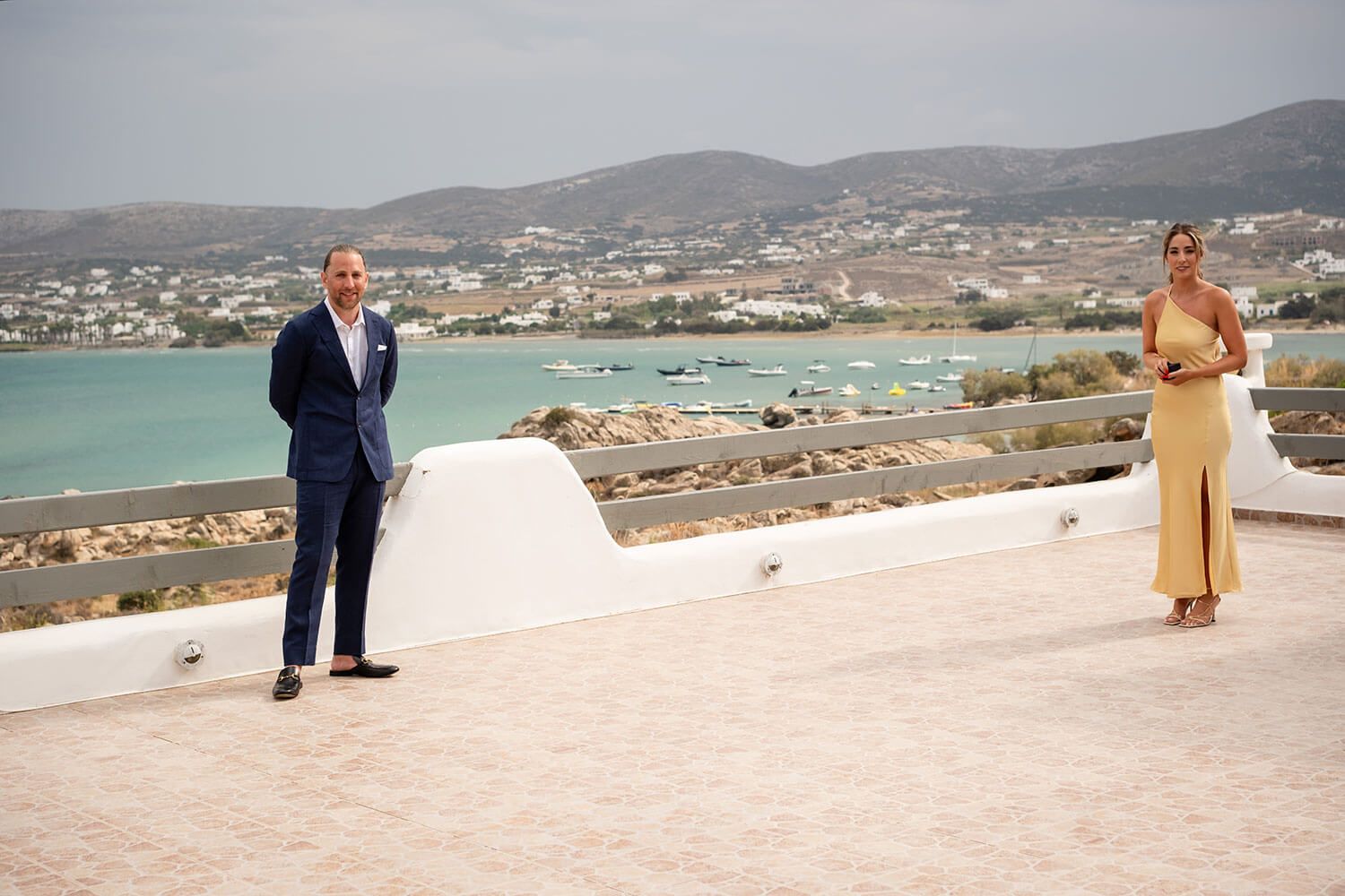 Groom waiting on the villa rooftop for his bride in Paros
