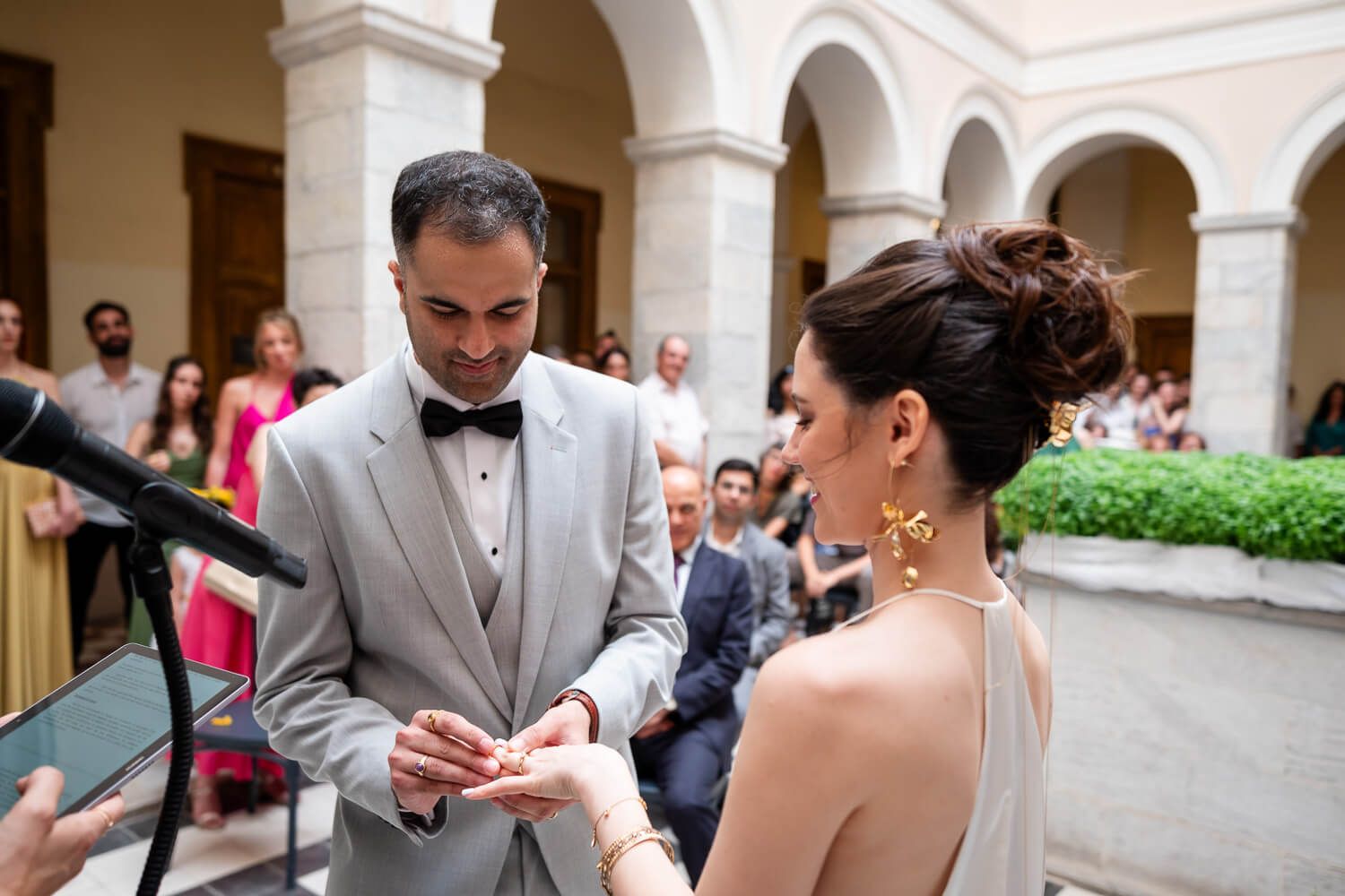 Couple exchanging rings during their wedding ceremony in Ermoupolis