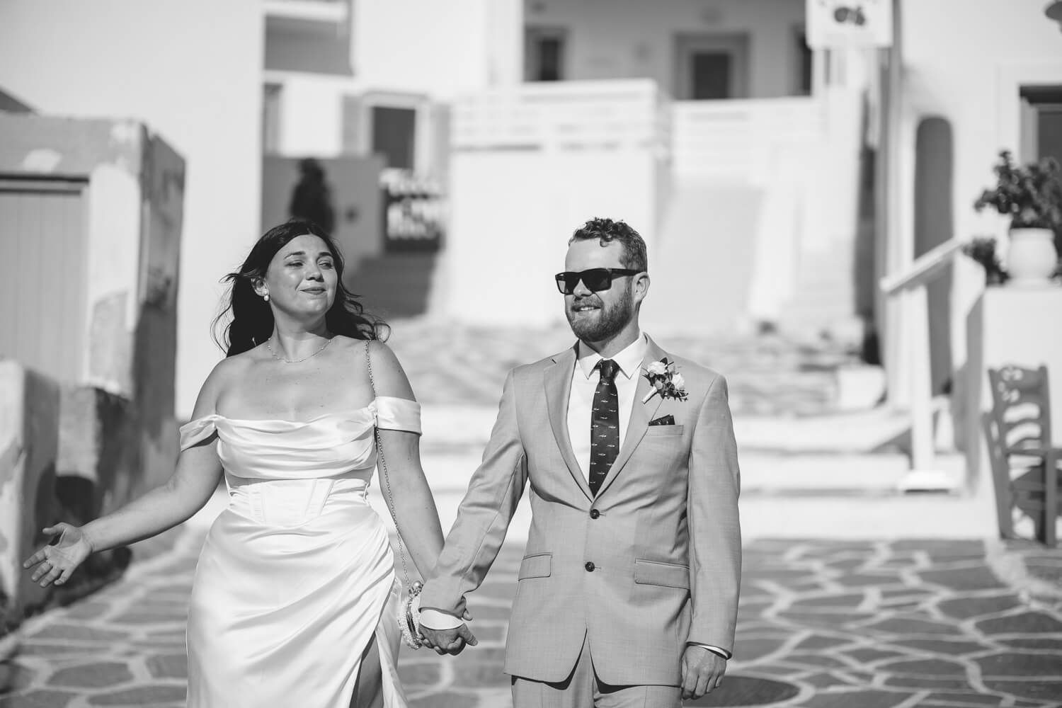 Hand in hand walk through white cobblestone streets