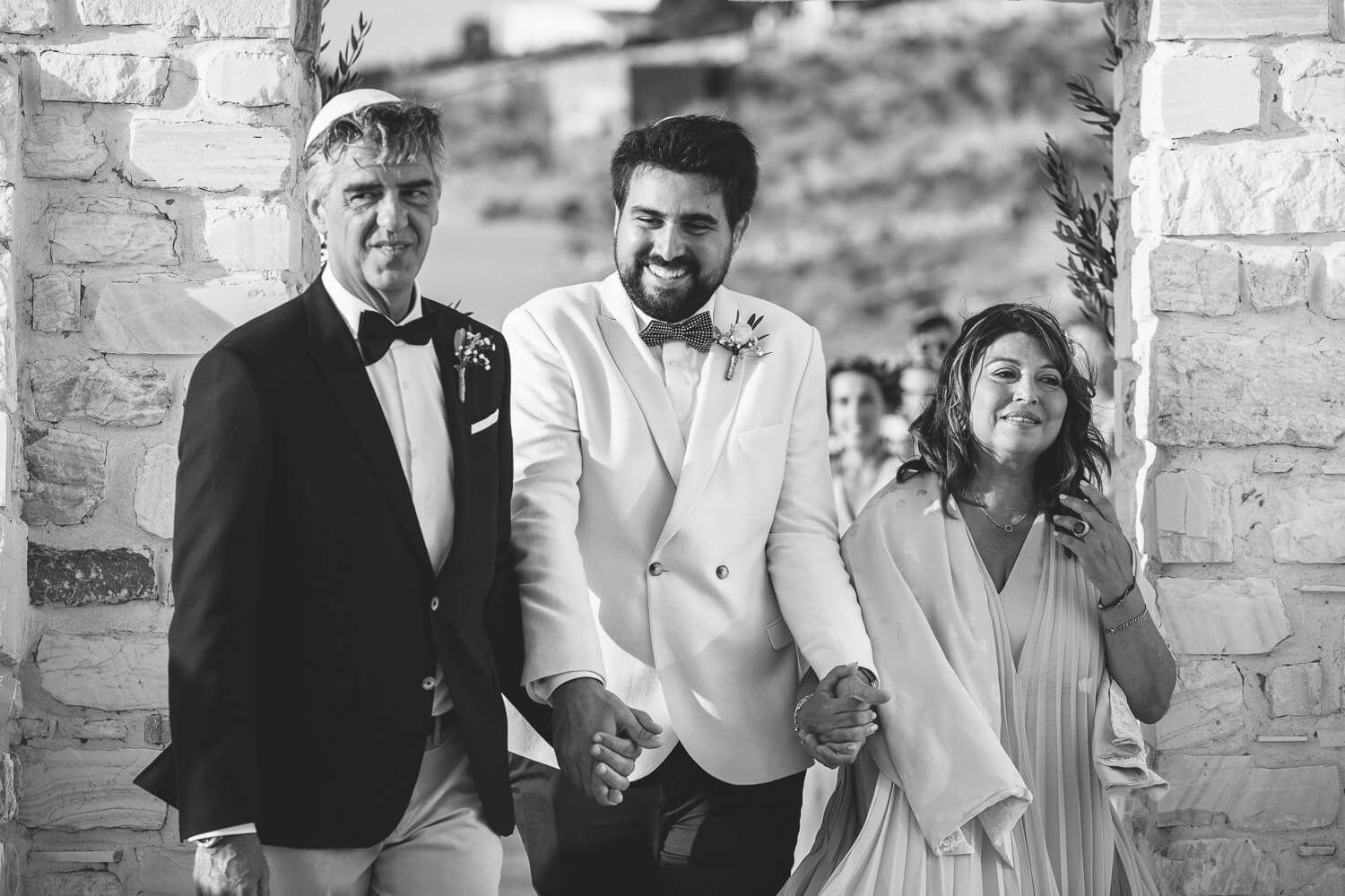 Groom entering ceremony area during a Jewish wedding in Paros