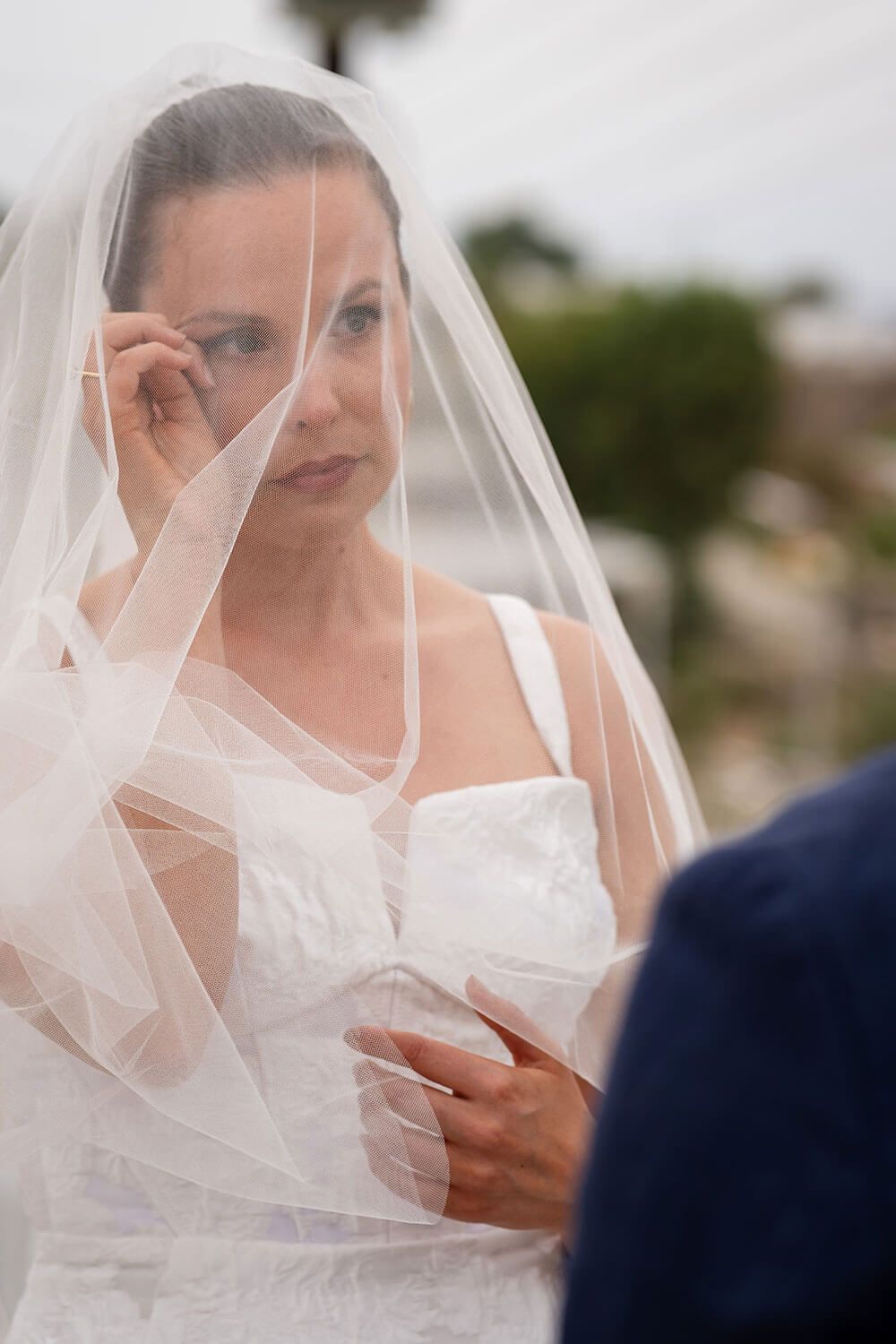Bride smiling warmly while exchanging vows at her Paros elopement