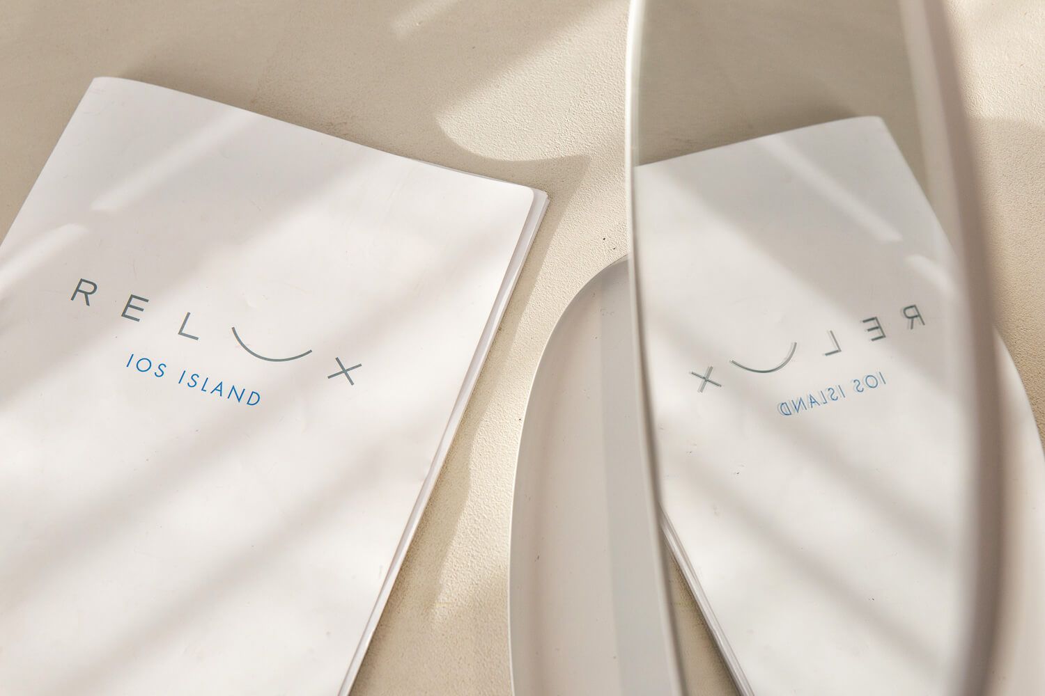 Minimalist white packaging design with subtle text and clean lines creates an elegant cosmetic product display.