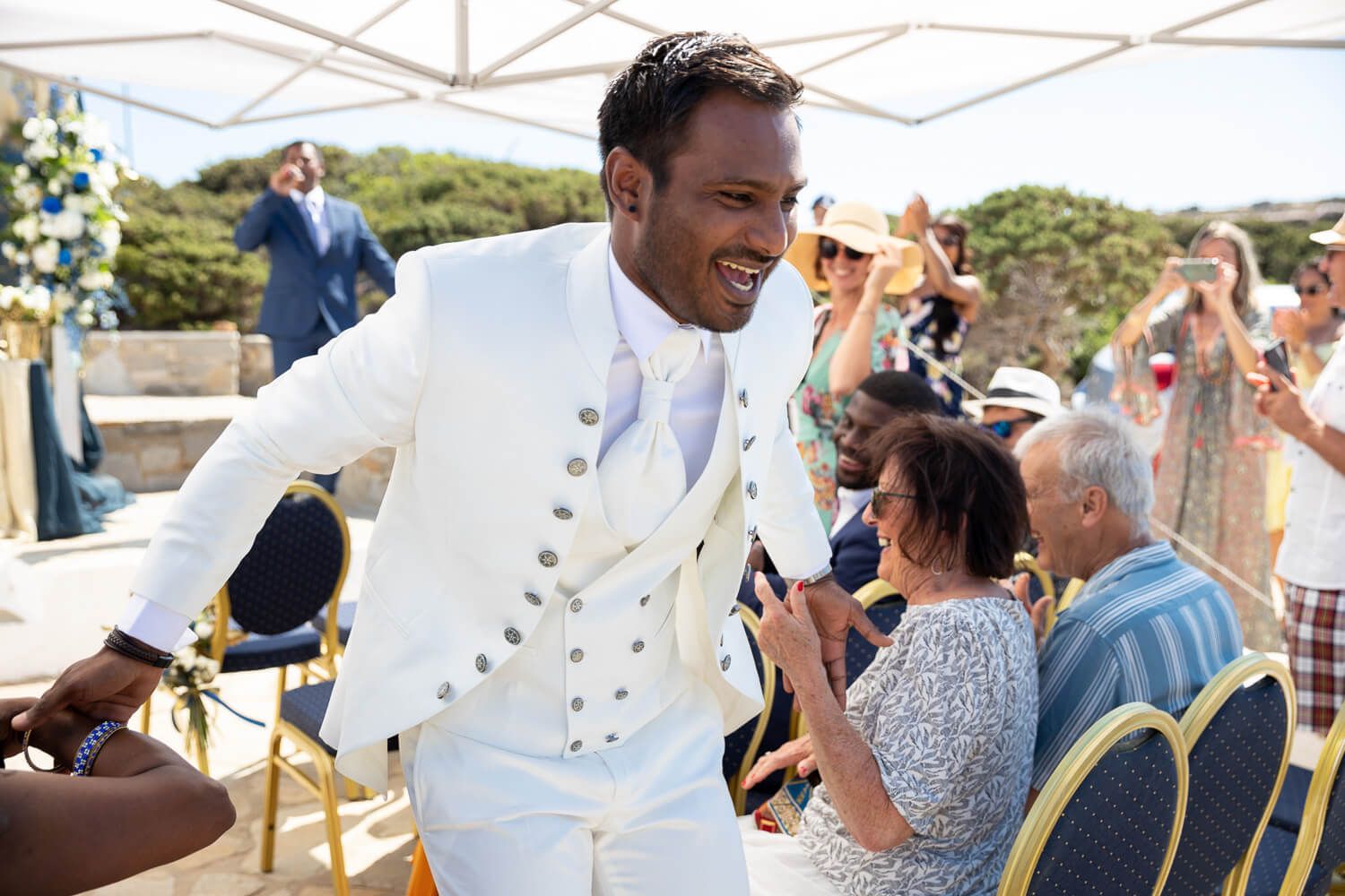 Groom arriving at the church for a symbolic wedding ceremony at Pyrgaki Paros