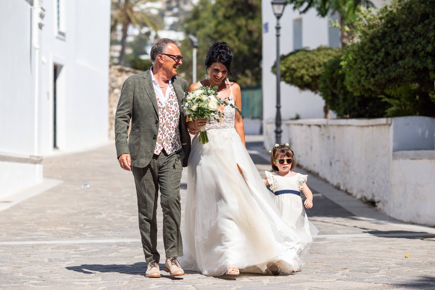 Bride walking towards the church through the narrow streets of Parikia