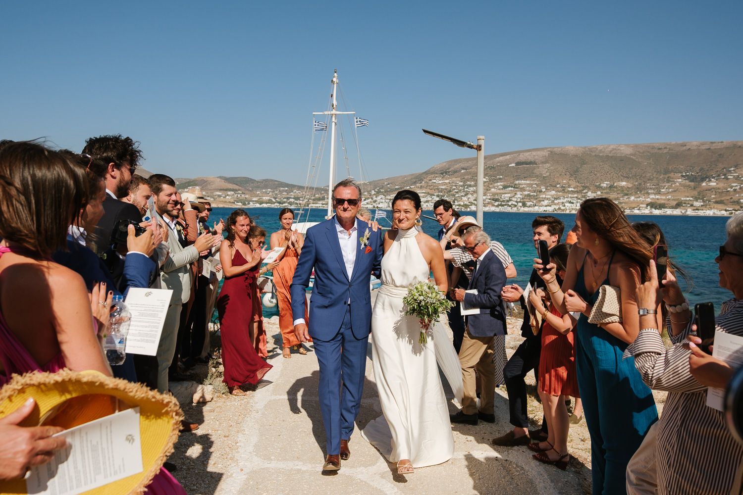 Bride arriving by boat at Agios Fokas chapel Paros