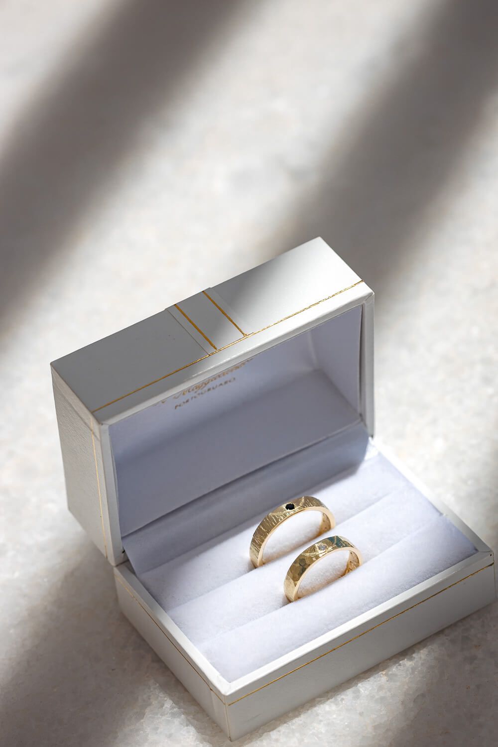 Bridal jewelry and rings laid out on a marble surface at Villa Aethra Paros
