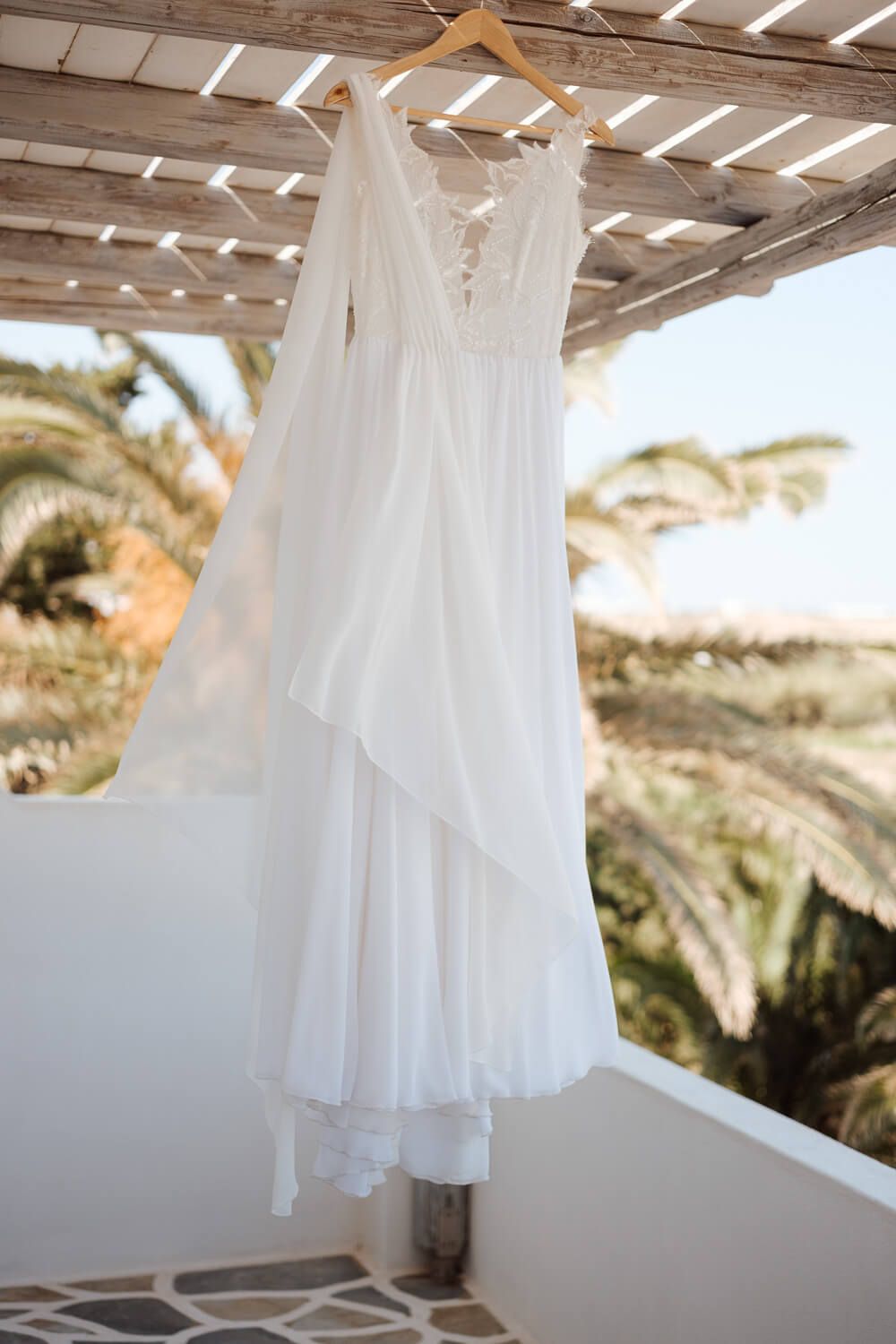 Wedding dress hanging with a beautiful view of the Aegean Sky