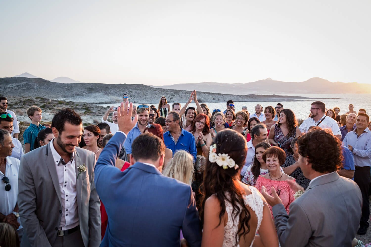 Wide shot of the wedding ceremony with the Aegean sea in the background