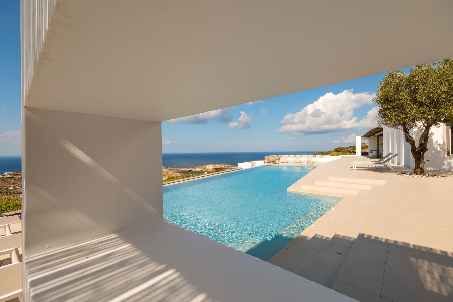 Asymmetrical architectural framing of the vast pool area