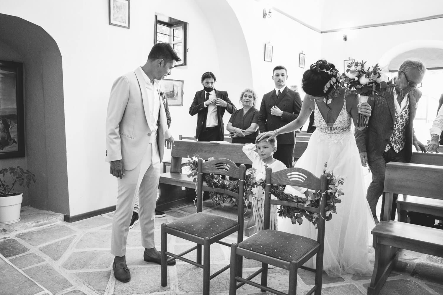 Erika and Marco holding hands while exchanging wedding vows in Paros