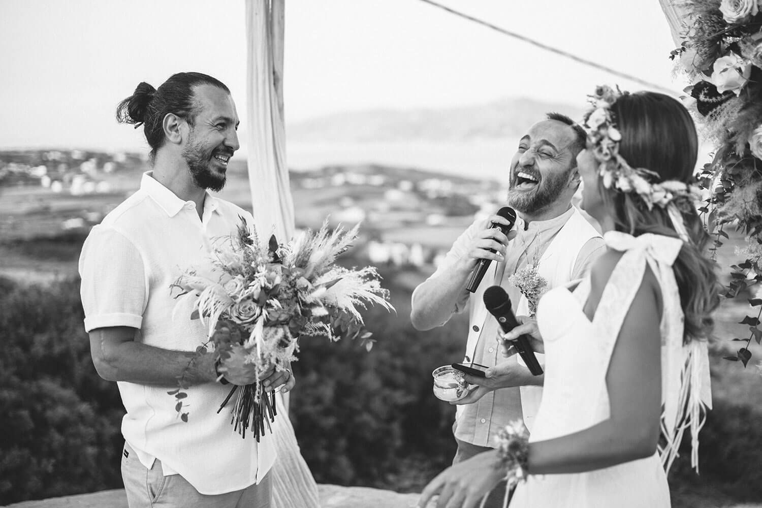 Guests smiling during a heartfelt boho wedding ceremony in Greece
