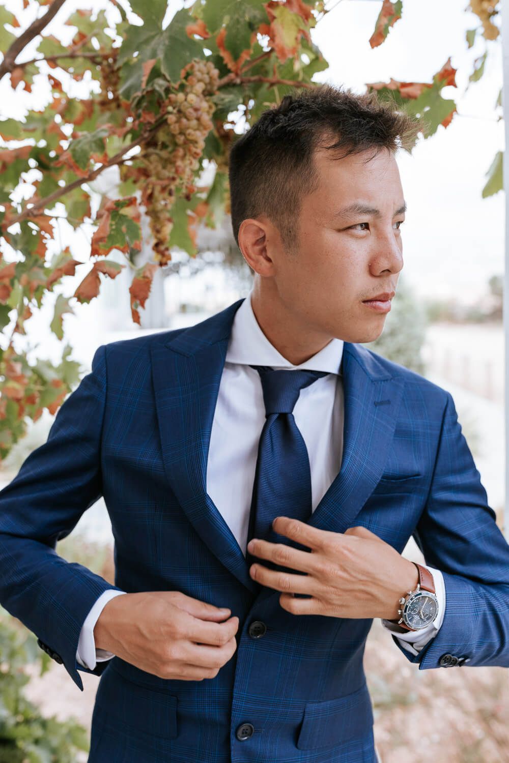 Putting on the groom's jacket