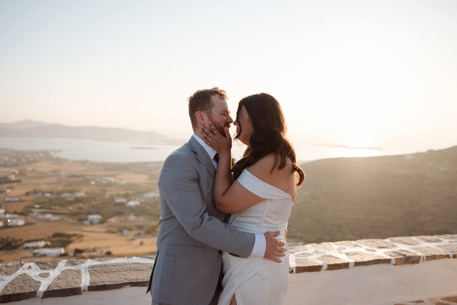 Romantic first kiss at sunset overlooking the Aegean Sea