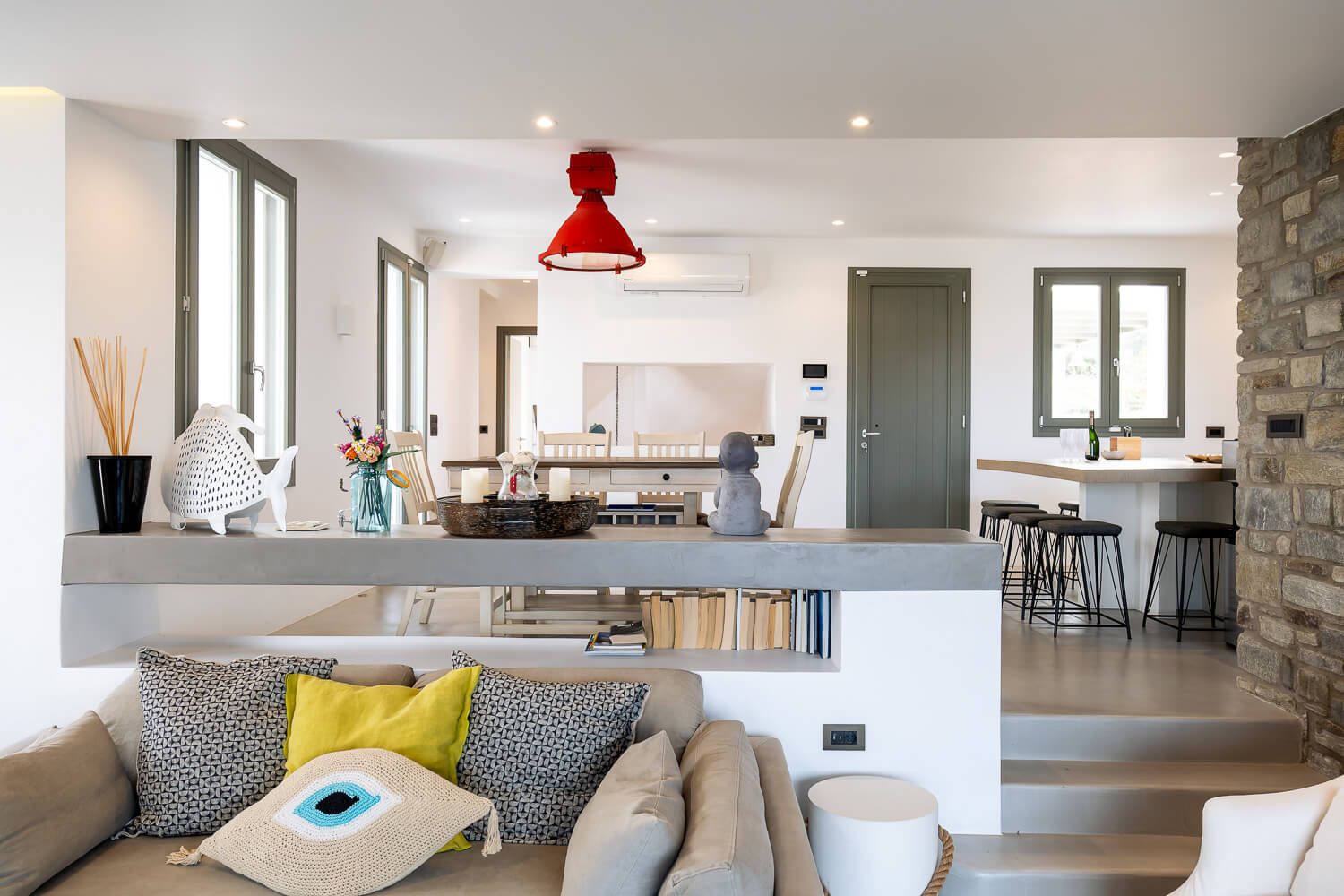 Modern open concept living room with white walls, hardwood floors and minimalist decor showcases a bright airy design.