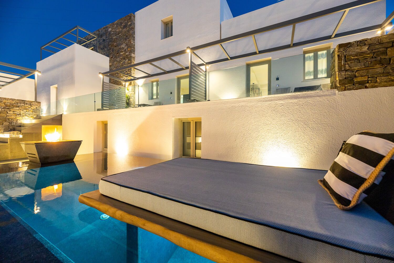 The serene evening atmosphere around the illuminated main pool