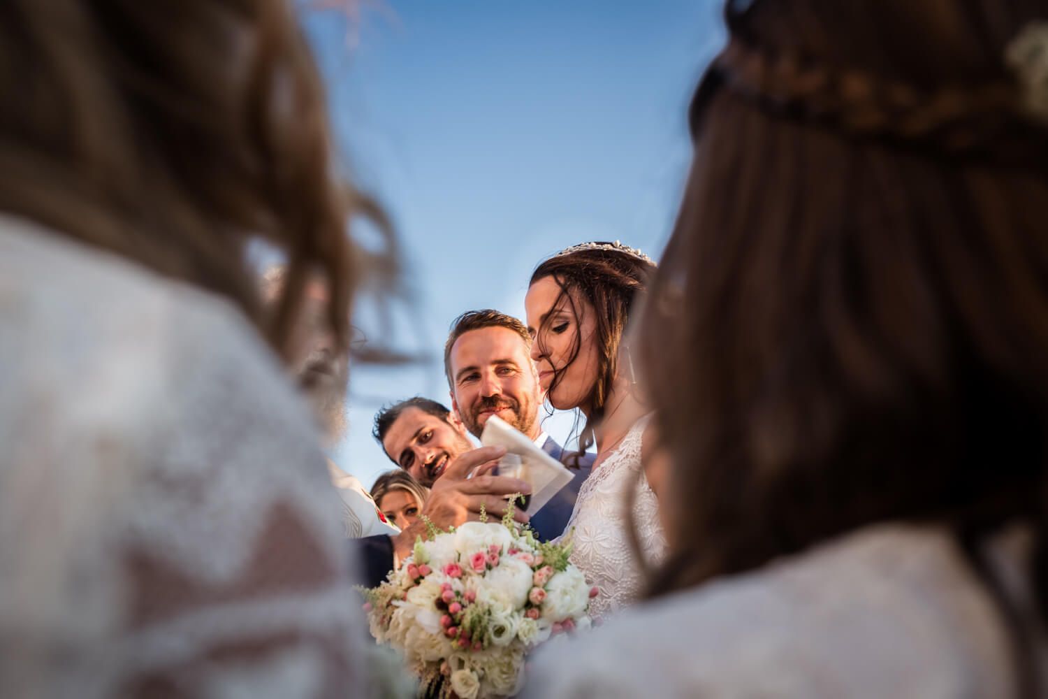 Spanish-Greek wedding ceremony in a white chapel in Milos